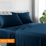 Navy blue bed sheets and pillowcases on a bed with 'Sailor Blue' label.