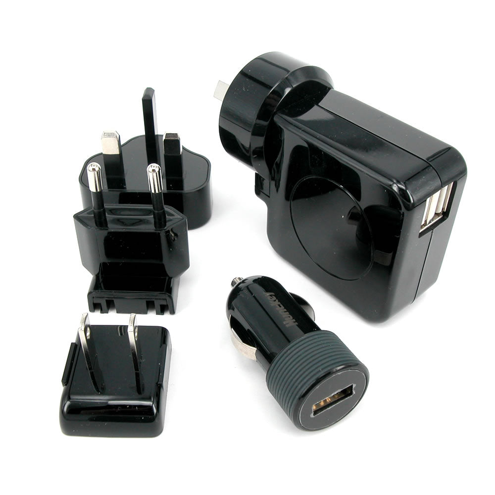 Set of black travel adapters including wall plug, car charger, and USB adapter on a white background