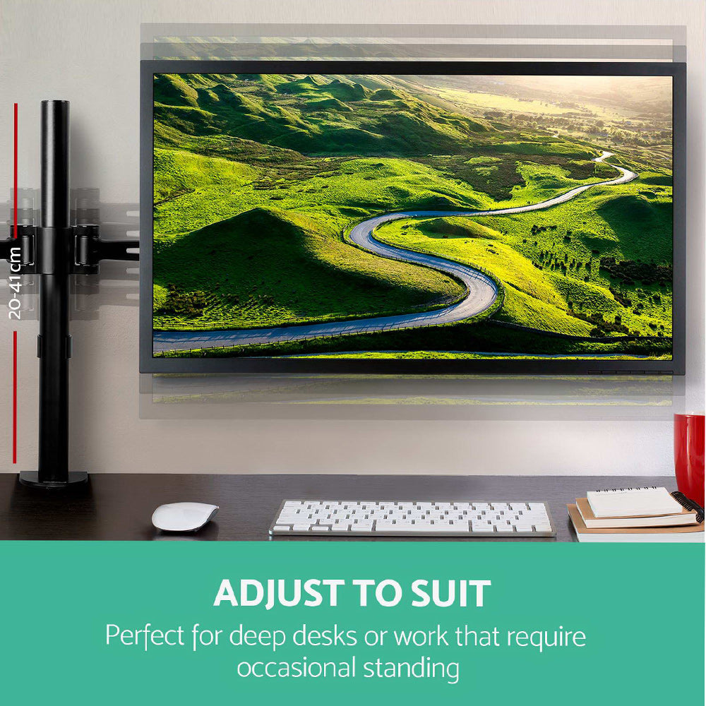 Computer monitor on a desk with a scenic display, adjustable arm shown.