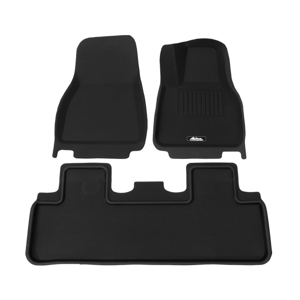 Set of black car floor mats on a white background