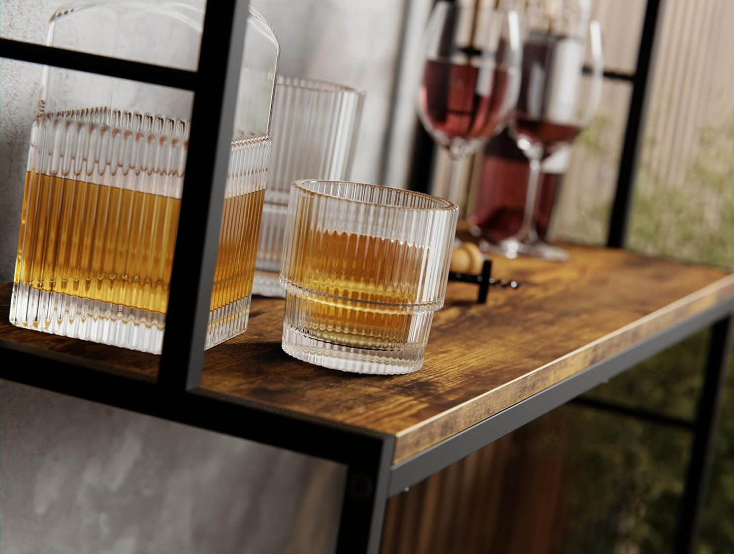 Two glasses of amber liquid on a wooden table with a blurred background