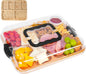 Lunch box with compartments containing various food items on a white background