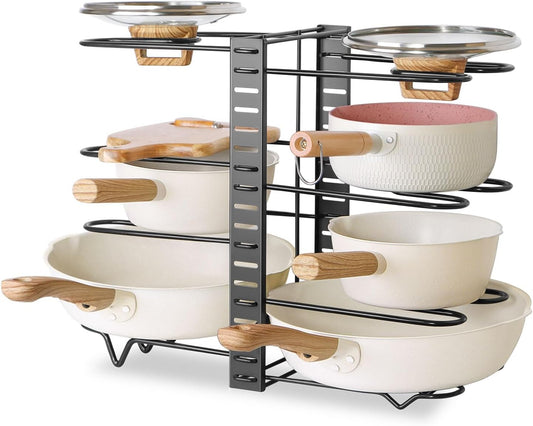 Stackable cookware organizer with pots and pans on a white background