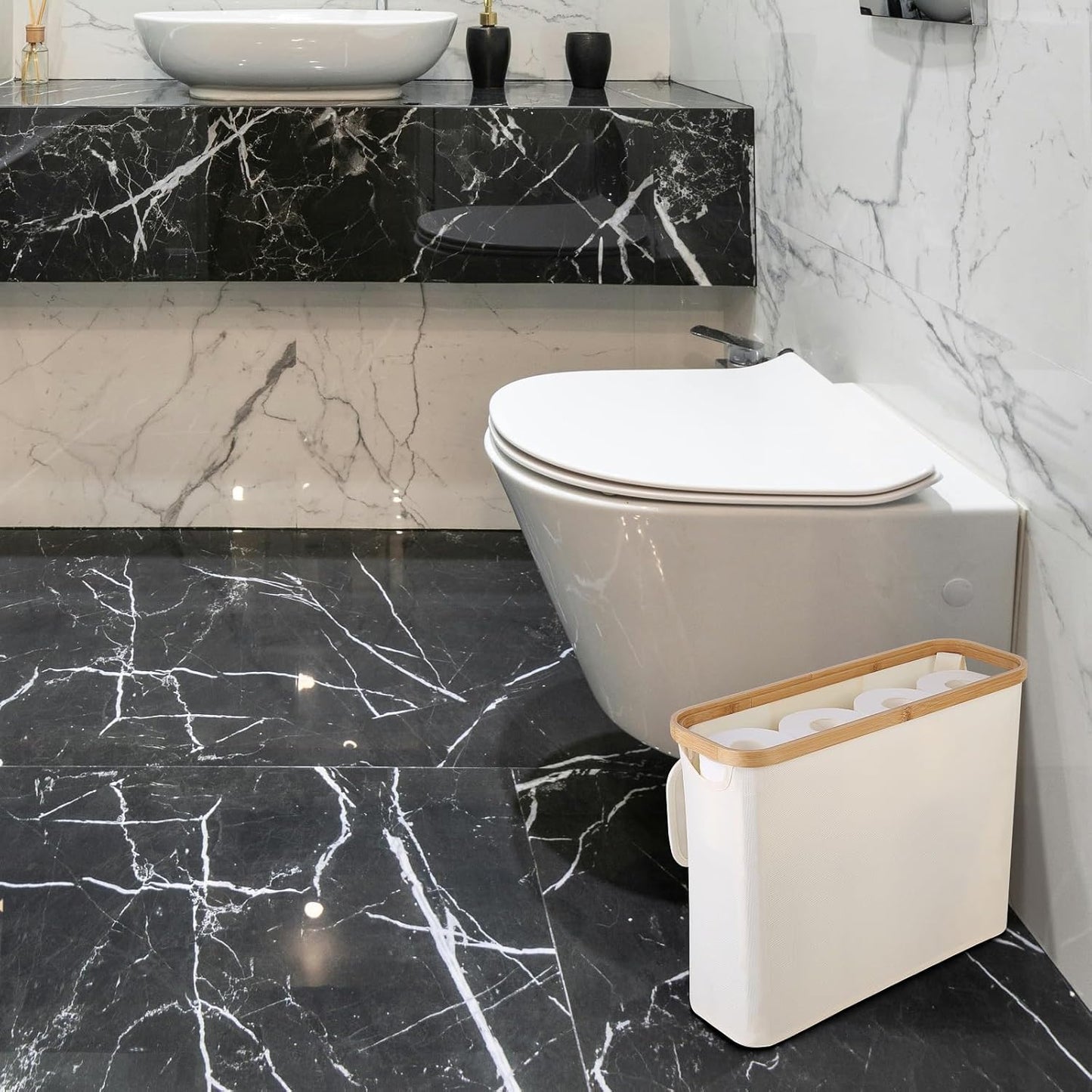 Bathroom with black marble floor, white toilet, and trash can.