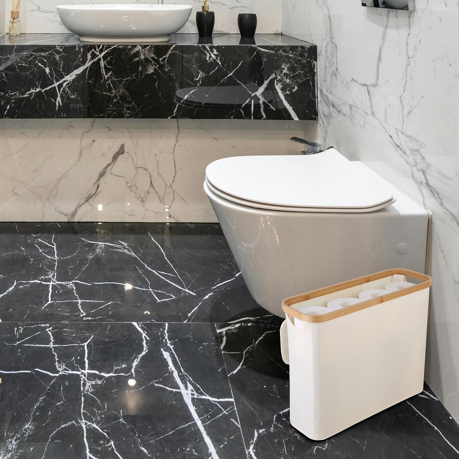 Bathroom with black marble floor, white toilet, and trash can.