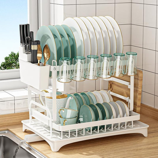 White dish rack with plates, glasses, and cups on a kitchen counter.
