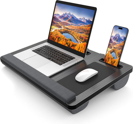 Laptop on a stand with a phone and mouse, both displaying mountain and lake scenery.
