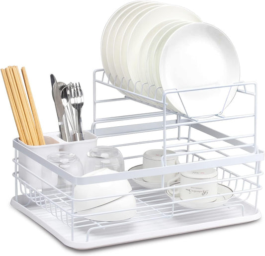 White dish rack with plates, bowls, and utensils on a white background
