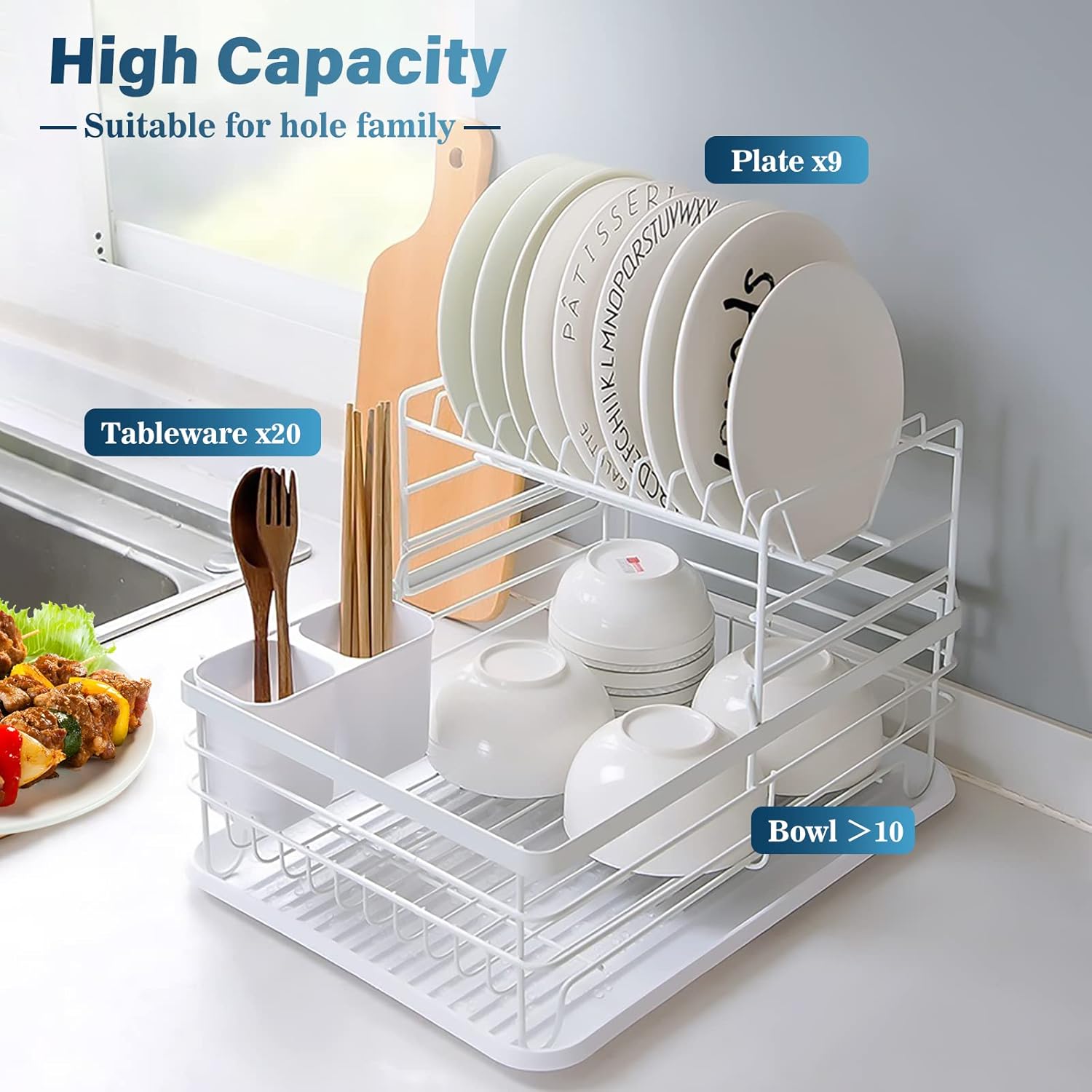 White dish drying rack with plates, bowls, and cutlery on a kitchen counter.