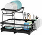 Black dish rack with dishes, cups, and utensils on a white background