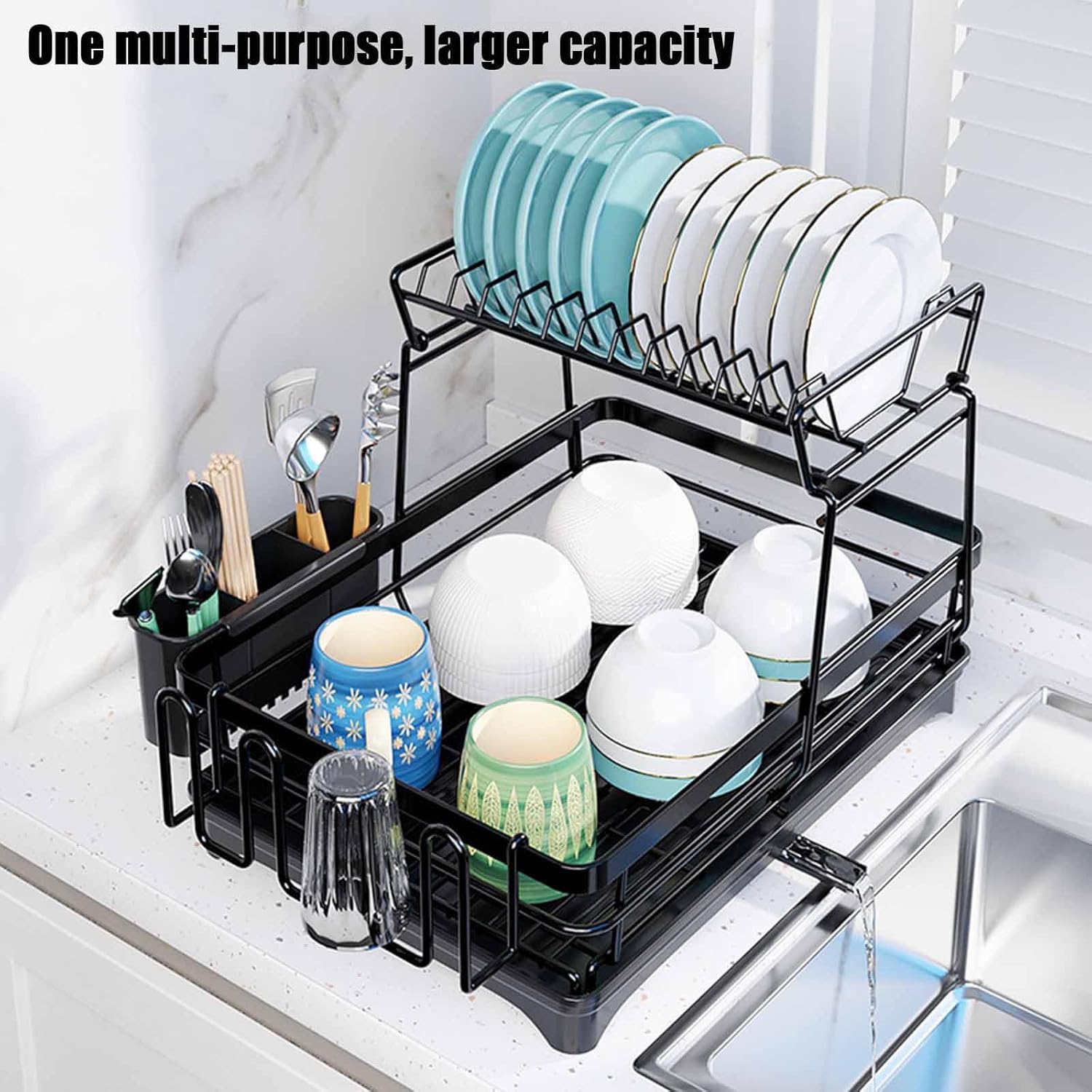 Black dish drying rack with plates, cups, and utensils on a kitchen counter.