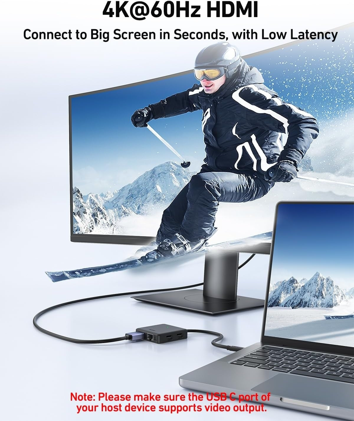 Laptop connected to a monitor with a person skiing displayed on screen, featuring 4K@60Hz HDMI technology.