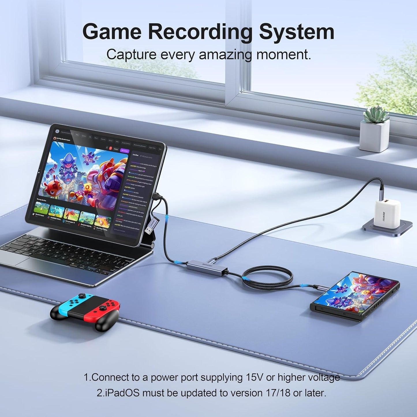Game recording system setup with tablet, smartphone, and remote control on a desk.
