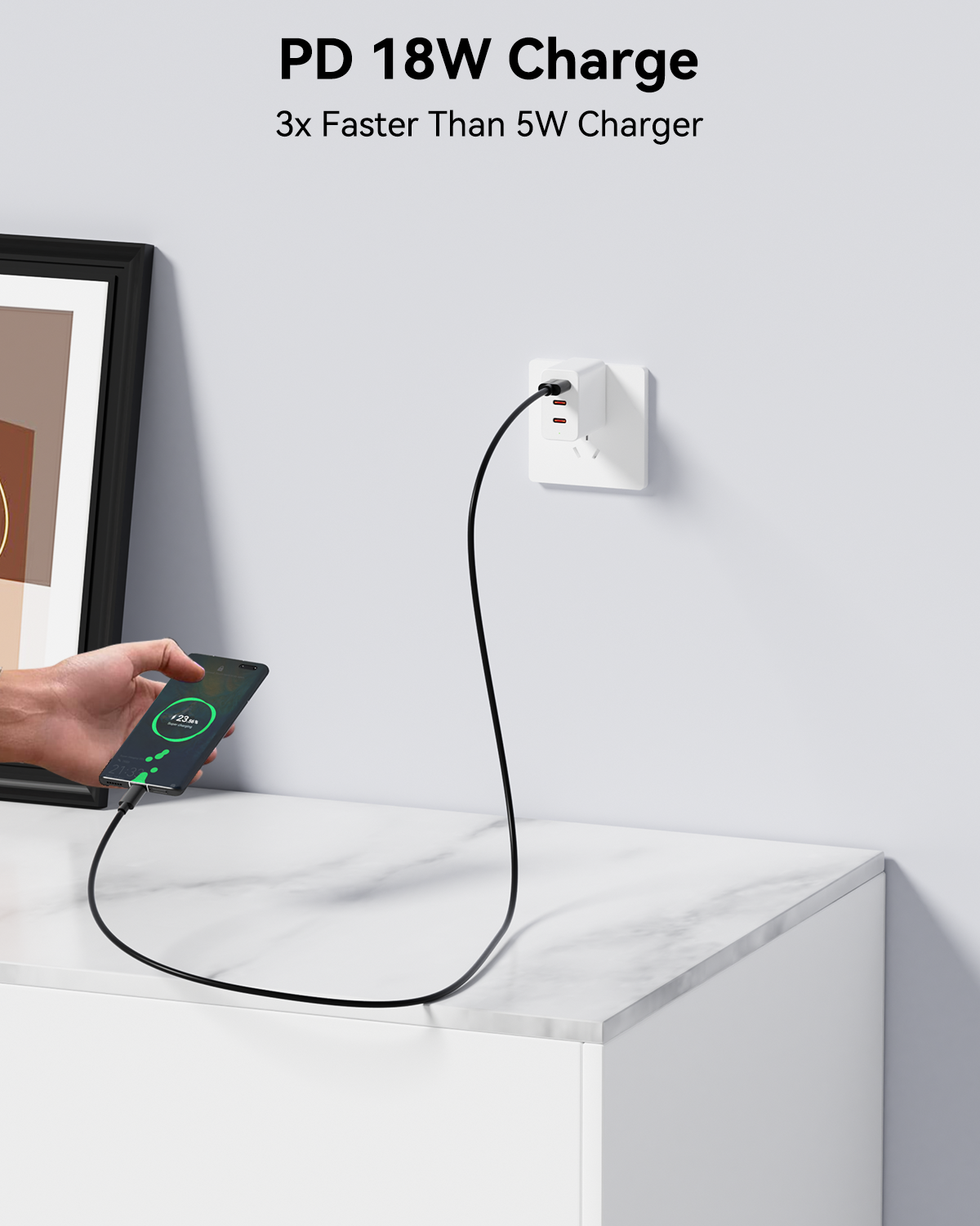 Phone being charged with a PD 18W charger on a white surface.