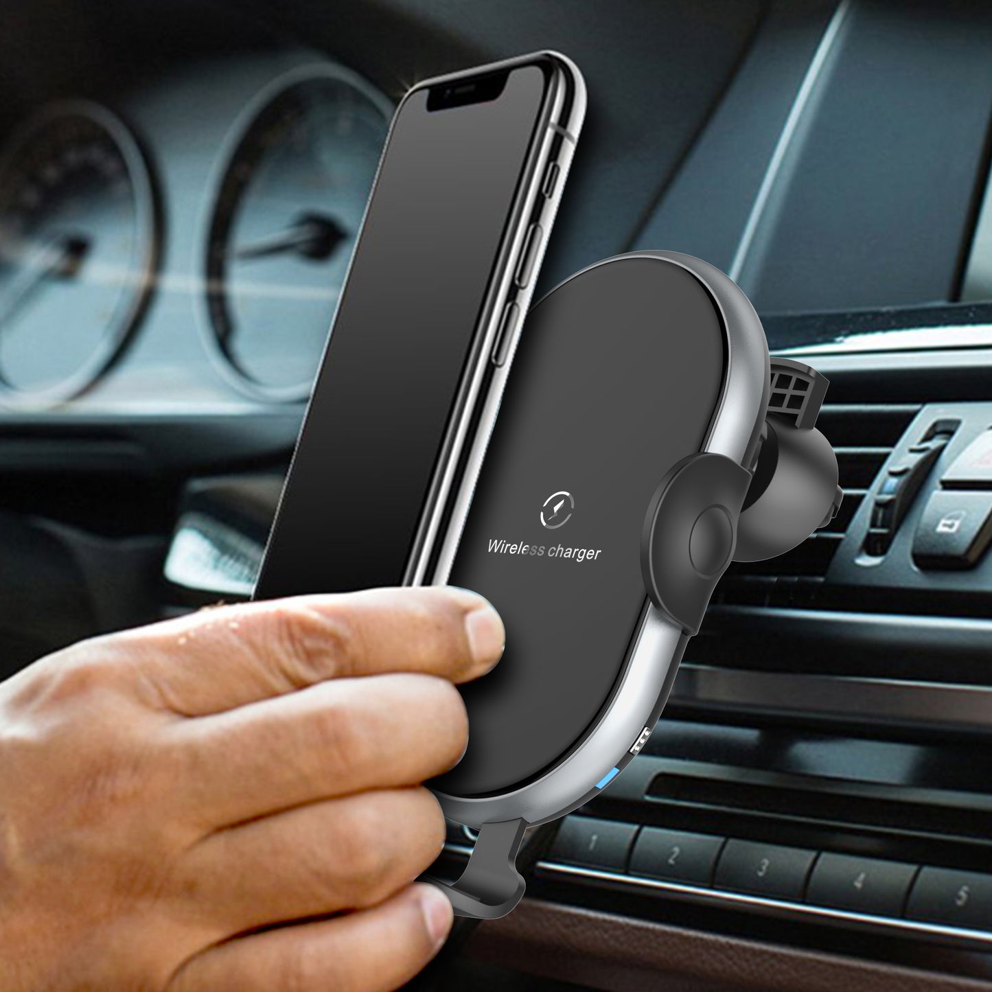Wireless phone charger in a car with a hand holding a smartphone