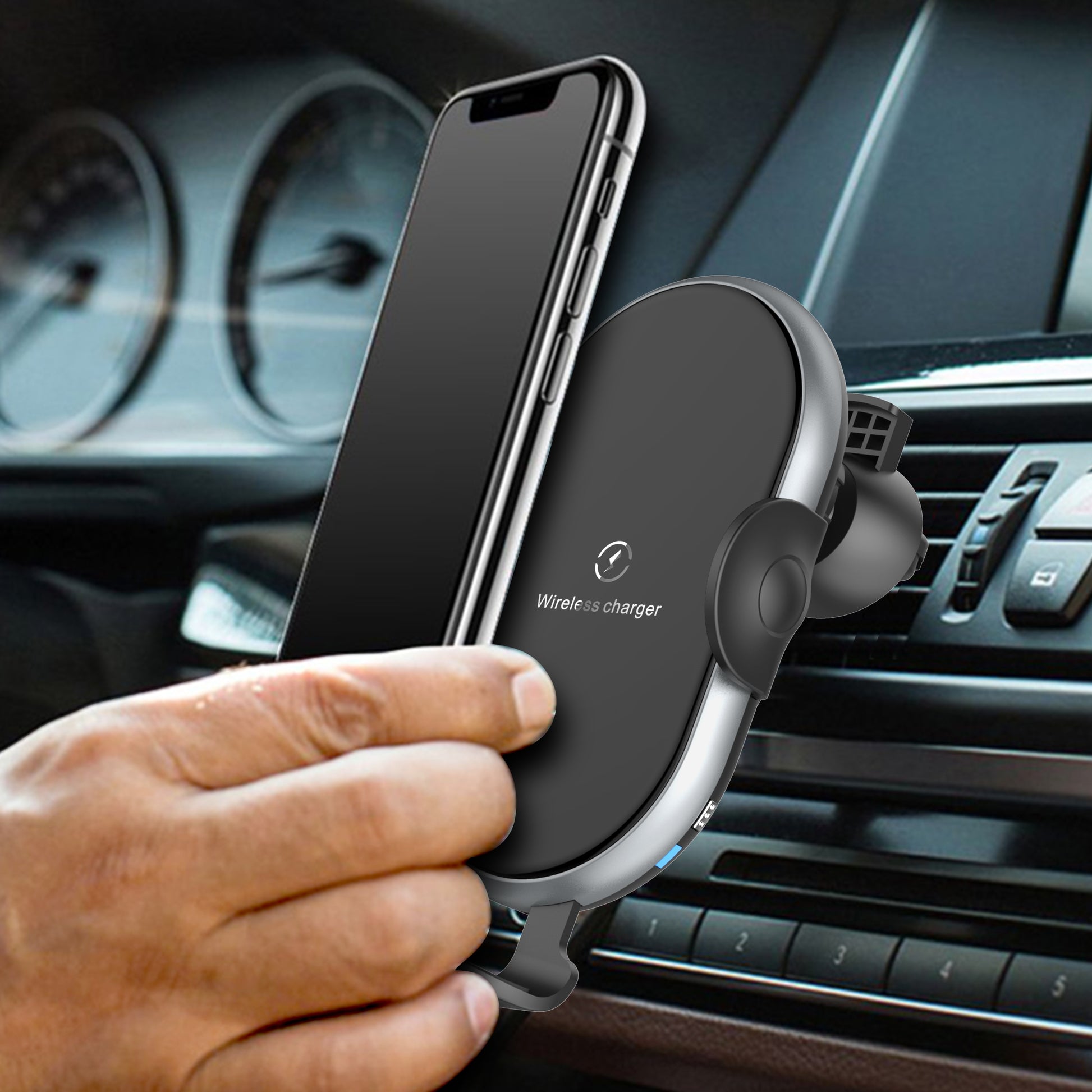 Wireless phone charger in a car with a hand holding a smartphone