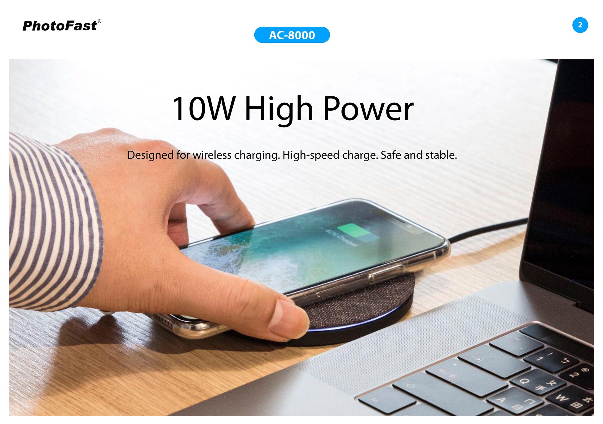 Person using a wireless charging pad with a smartphone on a desk next to a laptop, with PhotoFast branding.