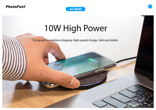 Person using a wireless charging pad with a smartphone on a desk next to a laptop, with PhotoFast branding.
