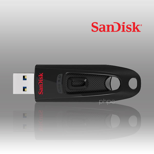 SanDisk USB flash drive on a reflective surface with a gray background